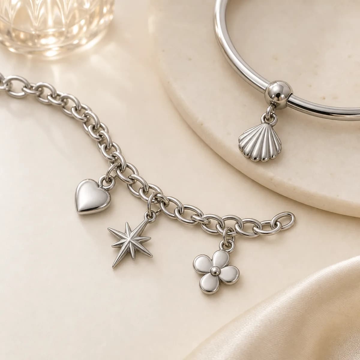 Small stainless steel charms attached to bracelet chain links