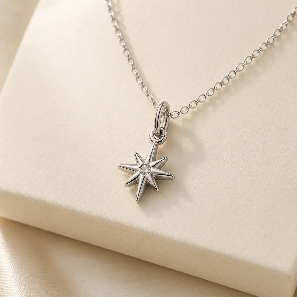 Stainless steel charm attached to a delicate necklace chain