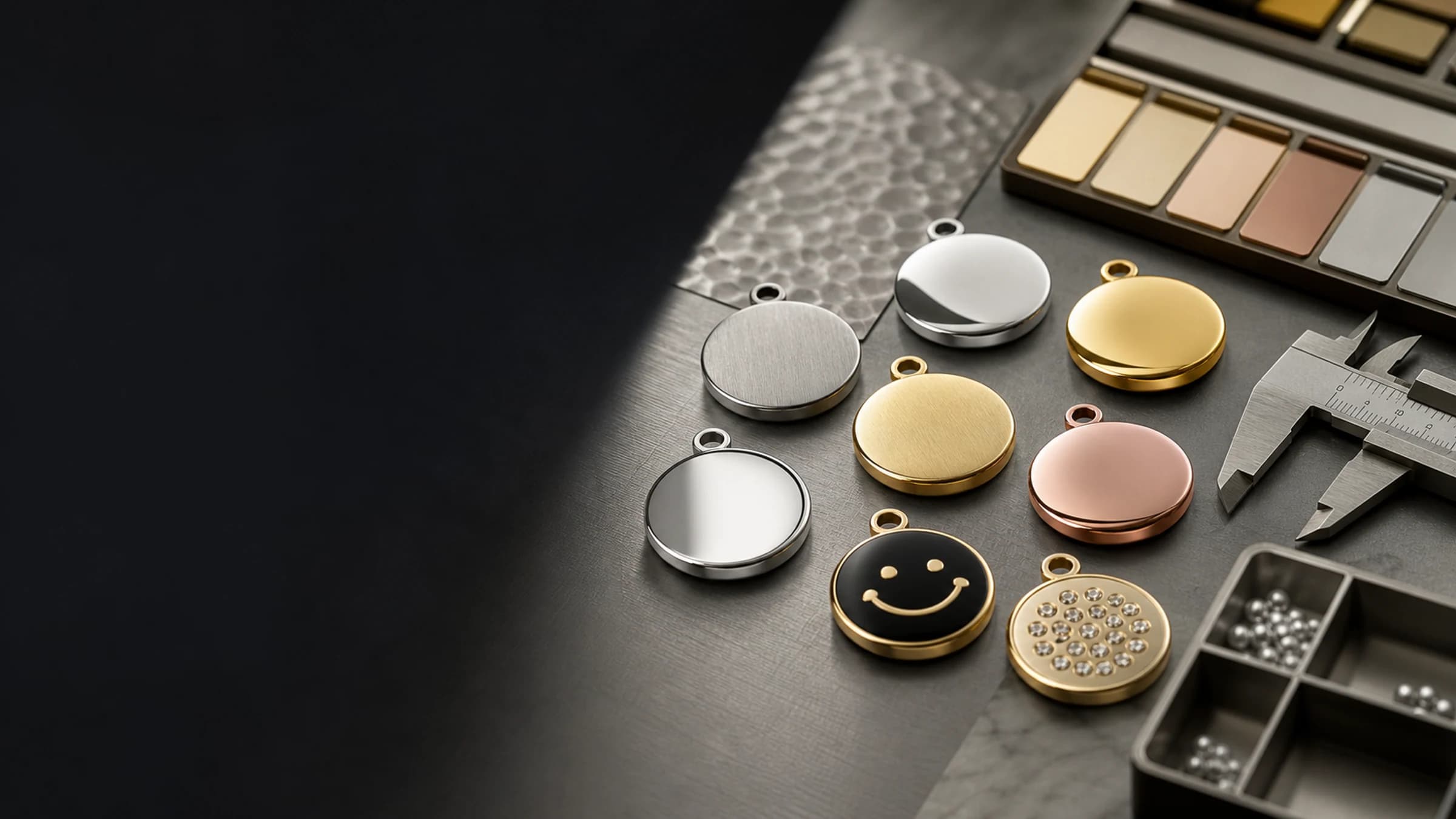 316L stainless steel charm material and PVD finish samples on a quality control workbench